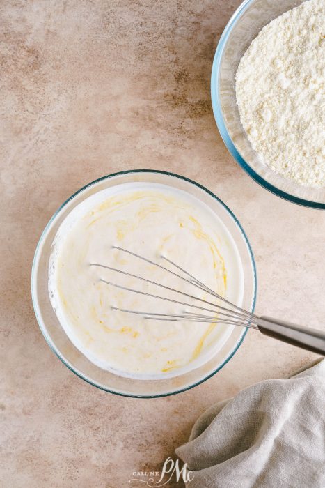 A bowl of flour and a whisk next to it.