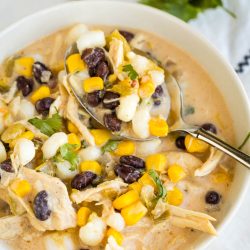 Creamy Chicken Hominy Soupin a bowl with corn and black beans.