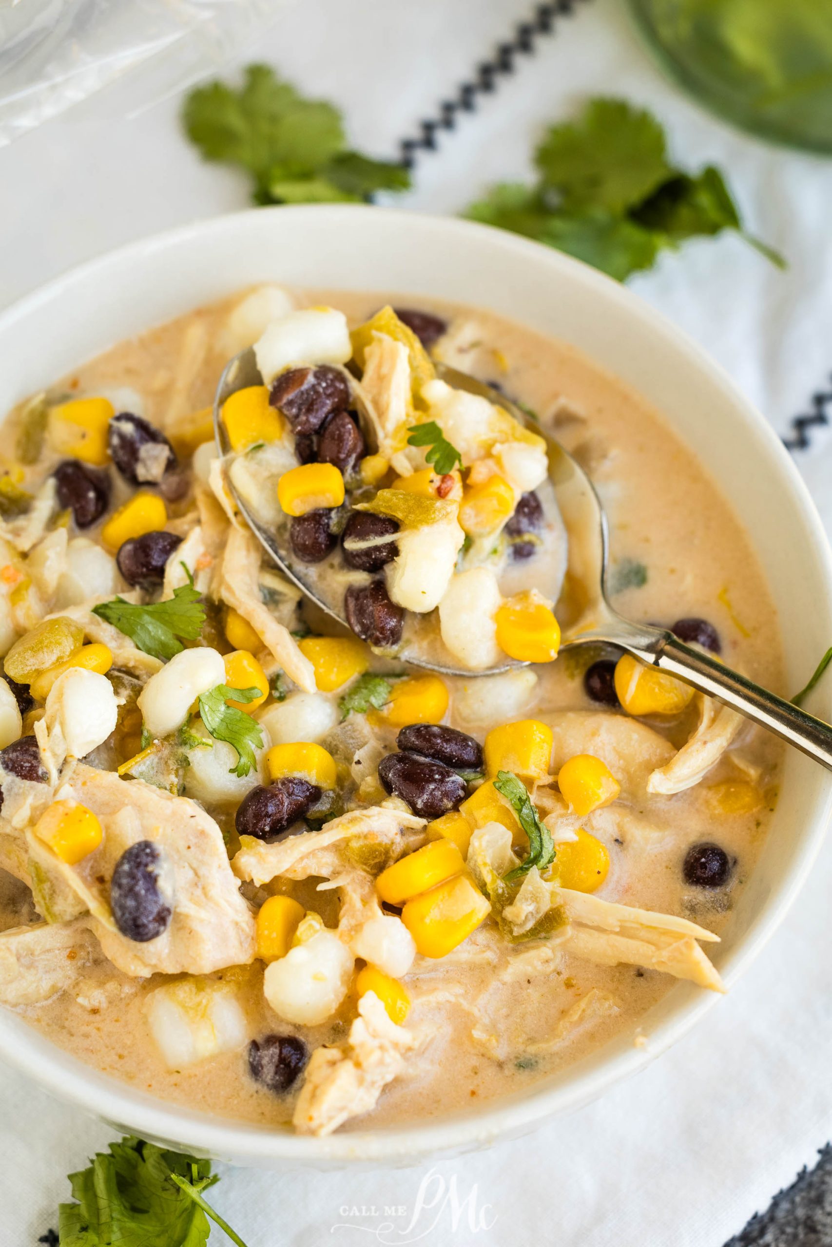 Creamy Chicken Hominy Soupin a bowl with corn and black beans.