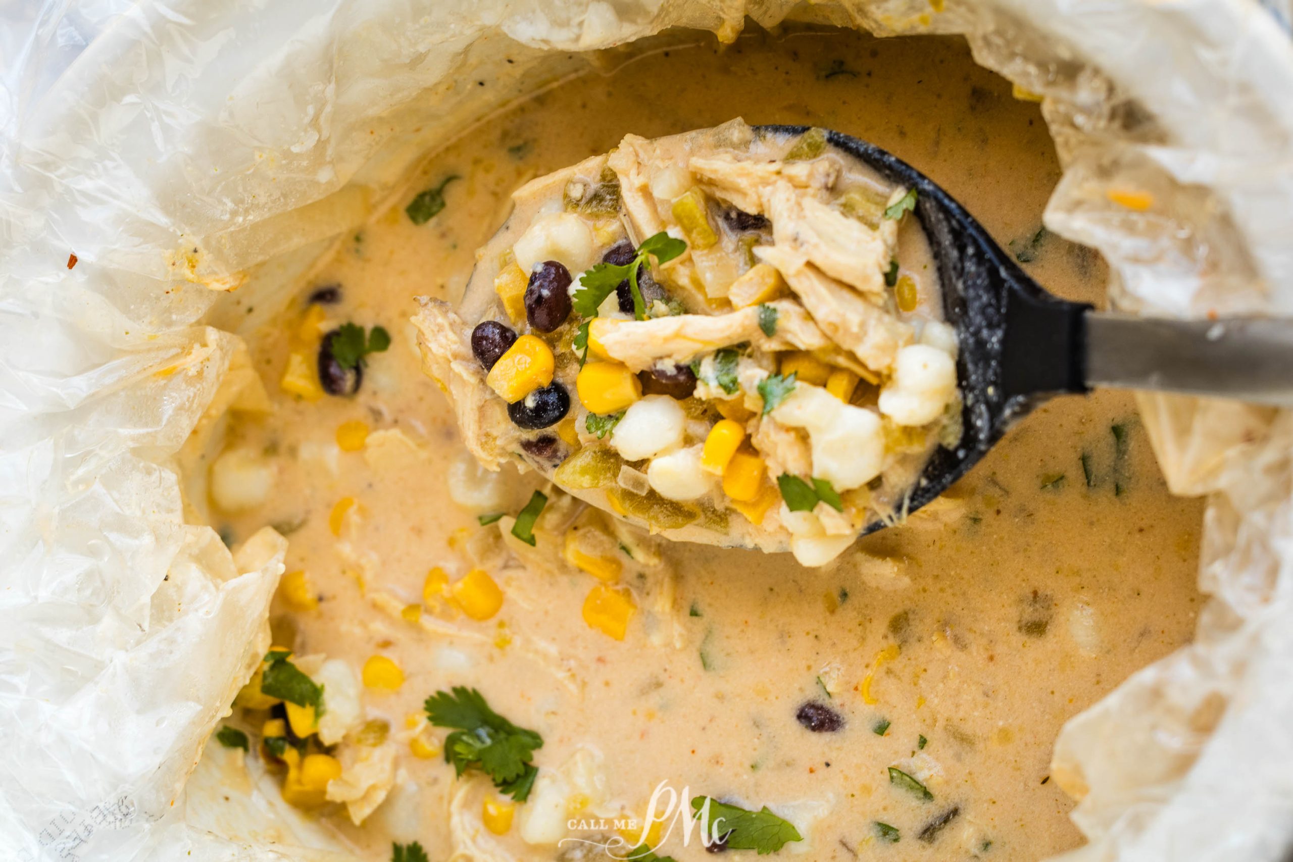 A bowl of mexican chicken chowder with corn and black beans.