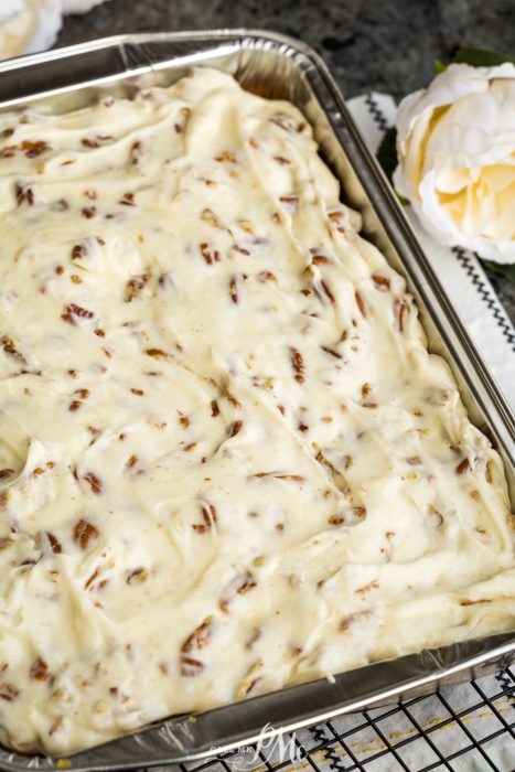 Elvis Presley Pineapple Poke Cake in a pan with pecans on top.