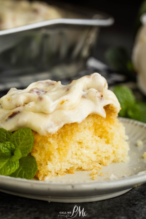 A slice of cake on a plate with mint leaves.