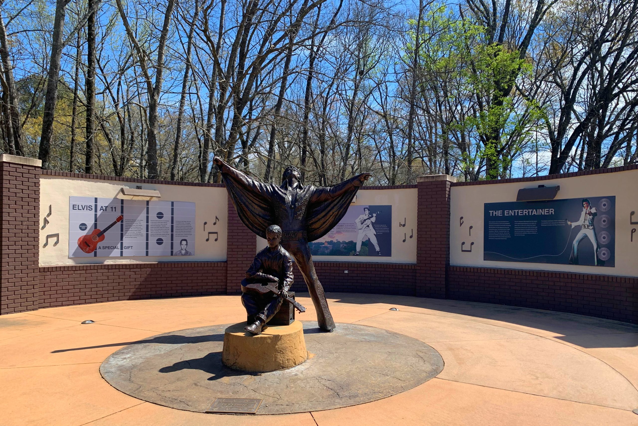 A statue of a Elvis Presley young and old.