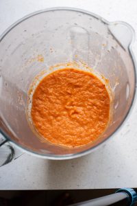 A glass bowl filled with a red sauce.