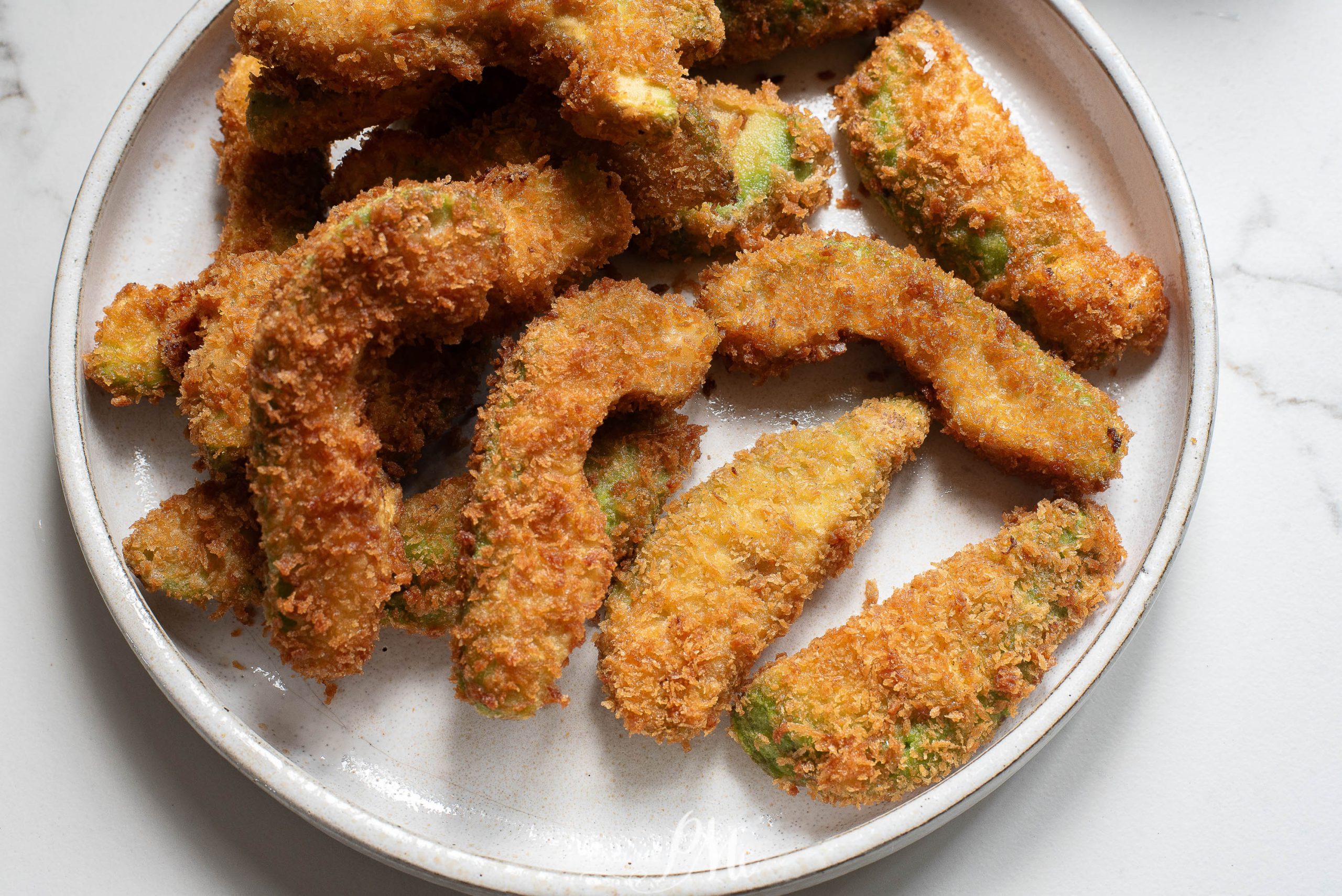 Fried green beans on a plate.