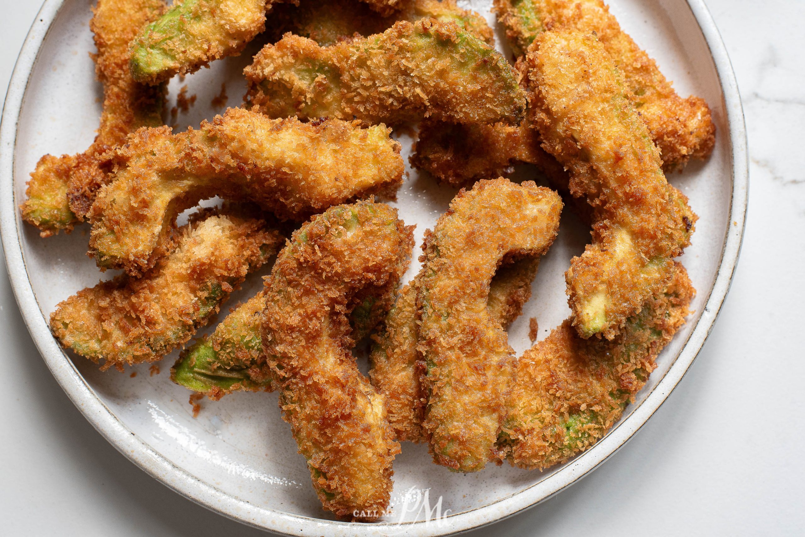 Fried avocado on a plate.