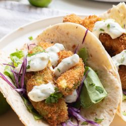Oven-fried avocado tacos on a white plate.