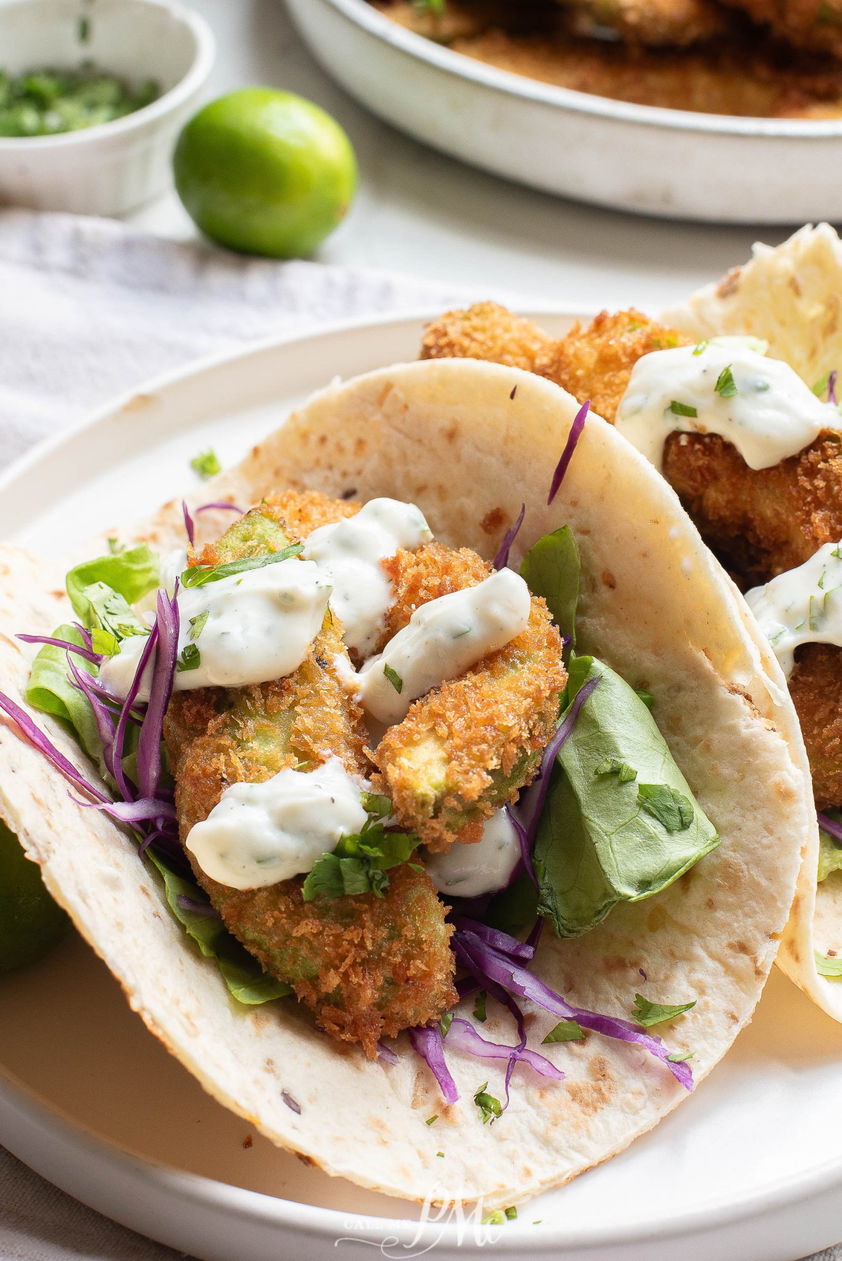 Oven-fried avocado tacos on a white plate.
