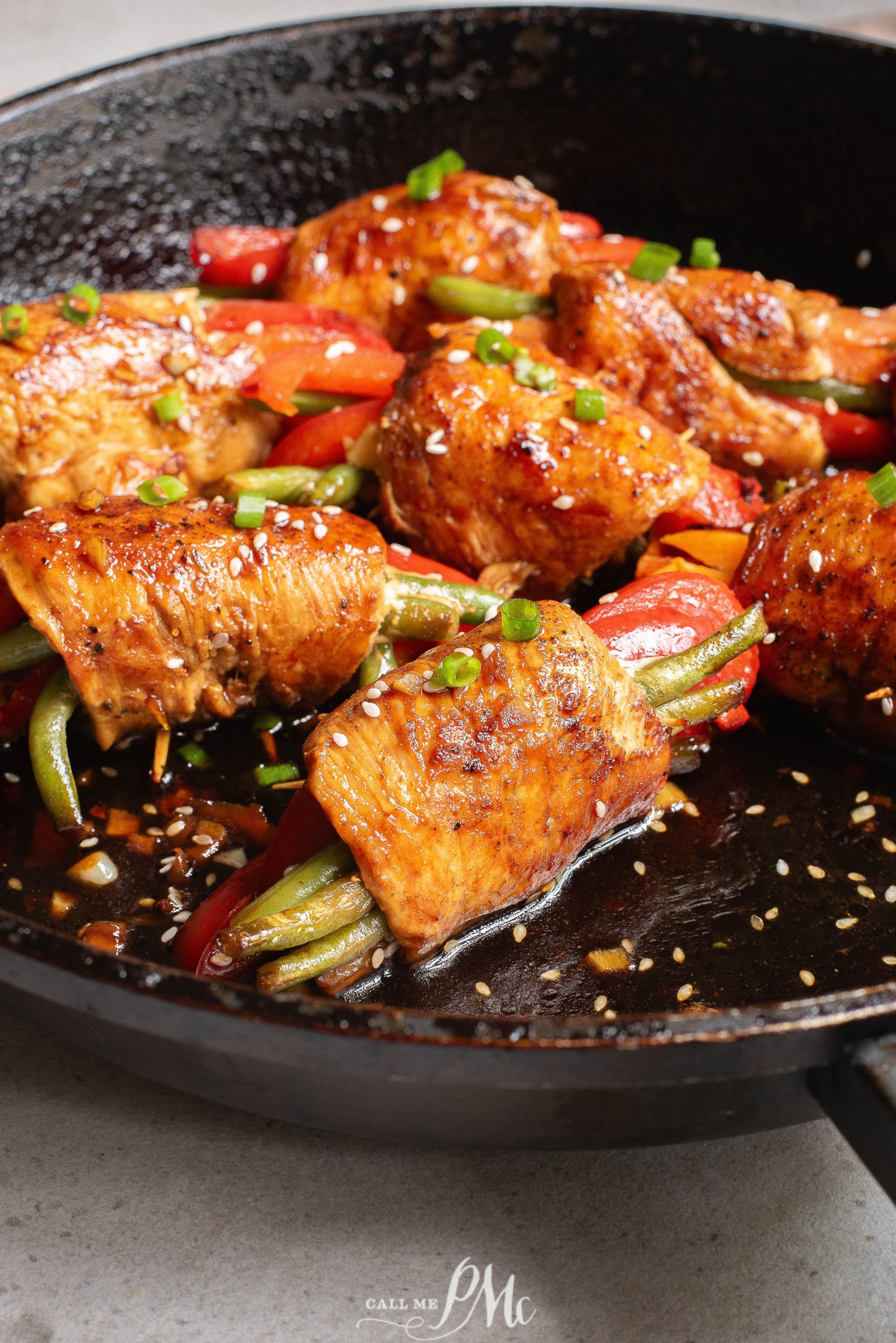 Chicken and peppers in a skillet.