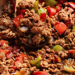 A skillet filled with meat and peppers.