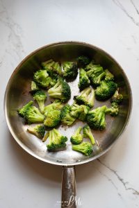 A frying pan with broccoli in it.