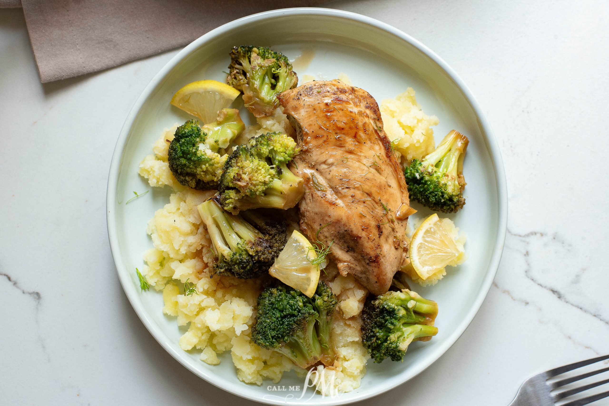 A plate with chicken, broccoli and mashed potatoes.