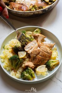 A plate of chicken and broccoli with a fork.