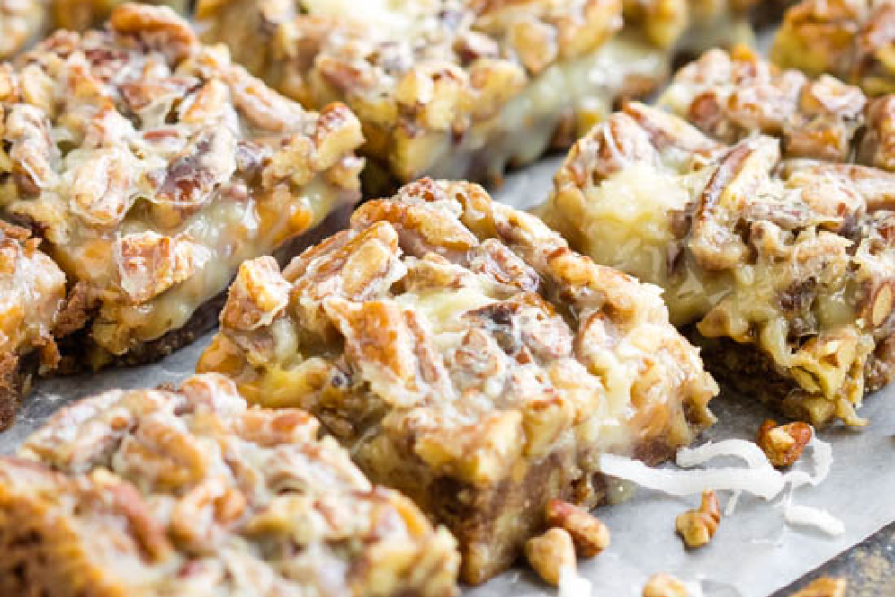 Pecan bars on a baking sheet.