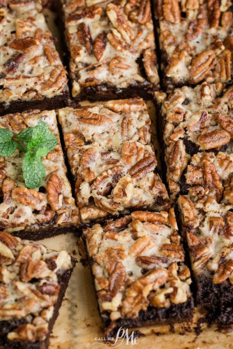 Brownies with pecans and mint on a baking sheet.