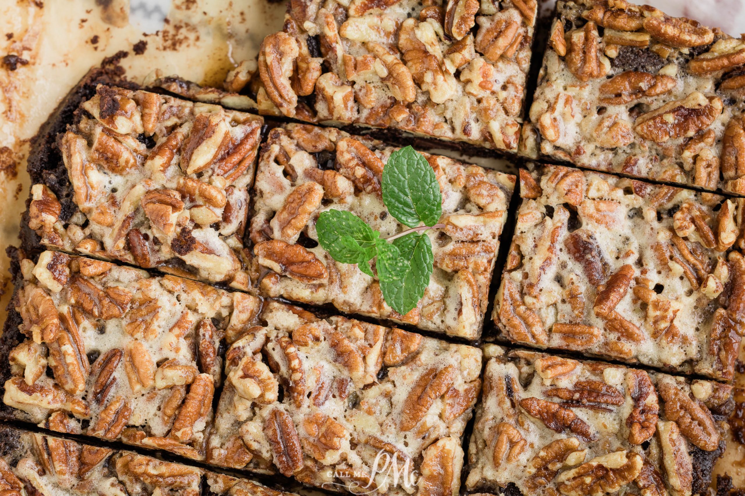 Chocolate pecan bars with mint sprigs.