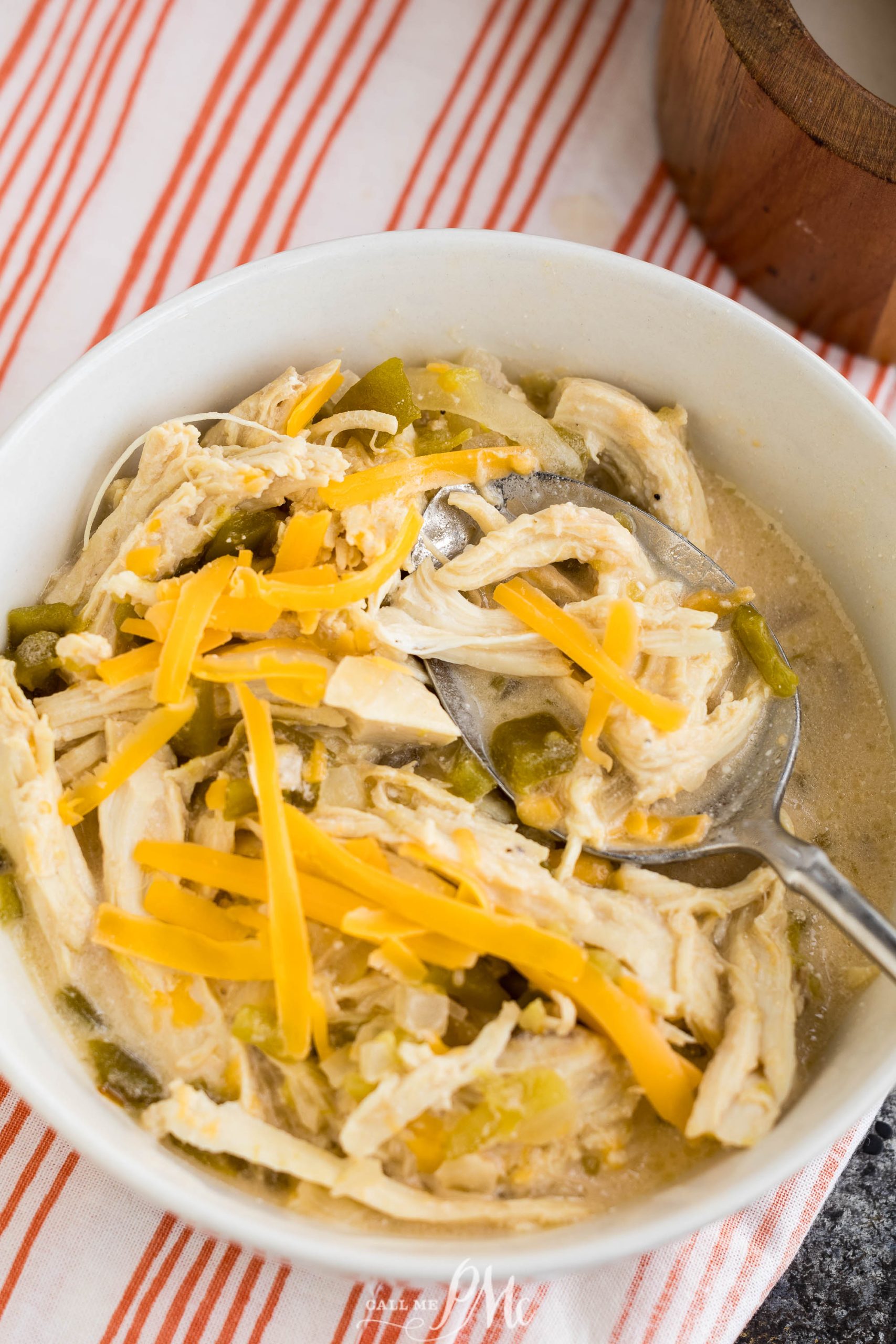 Slow Cooker Chicken Chile Relleno Soup in a bowl with cheese and green onions.