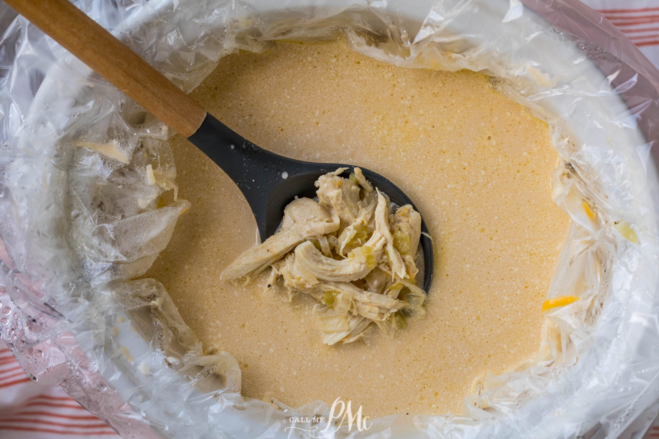 A bowl of Slow Cooker Chicken Chile Relleno Soup with a spoon in it.