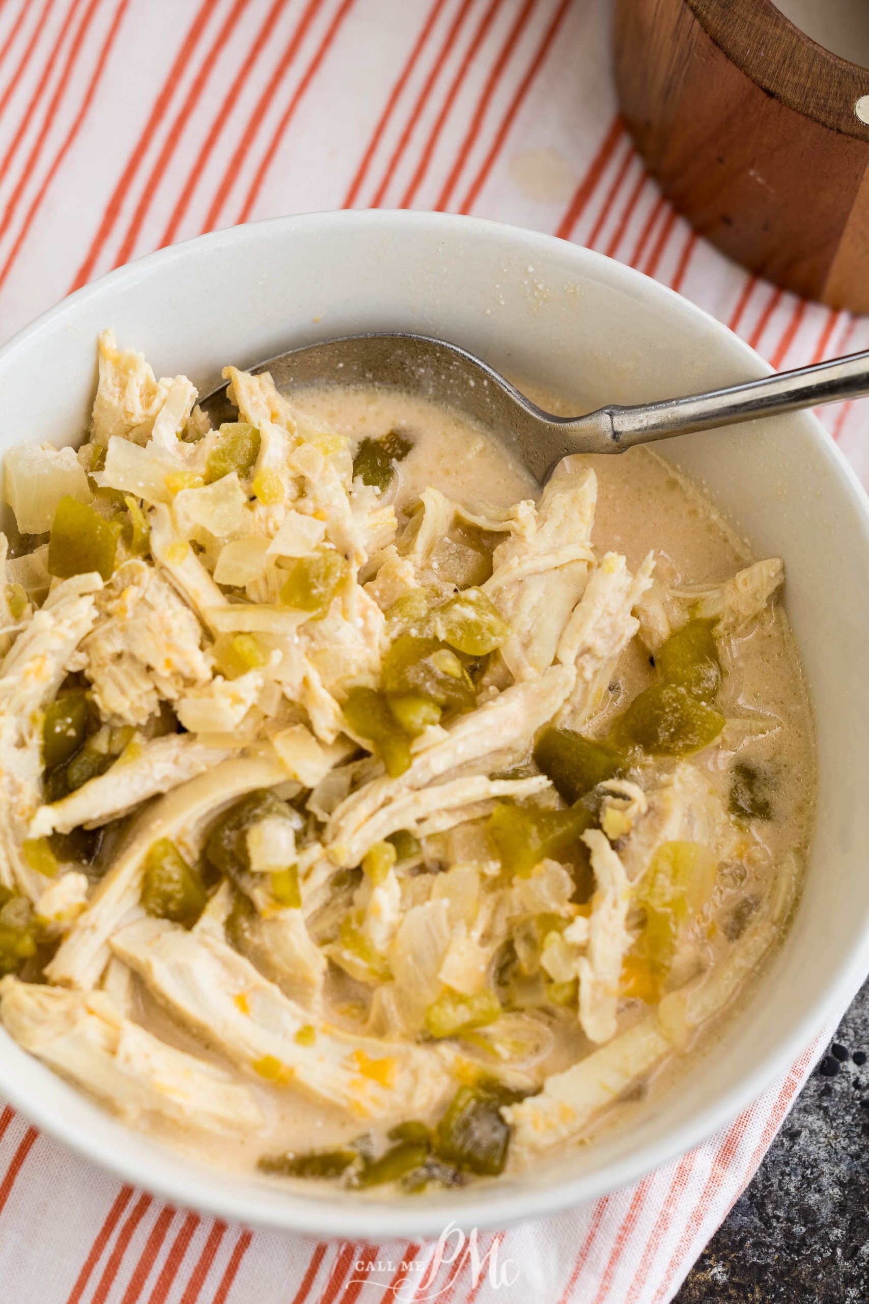 A bowl of Slow Cooker Chicken Chile Relleno Soup with peppers and onions.