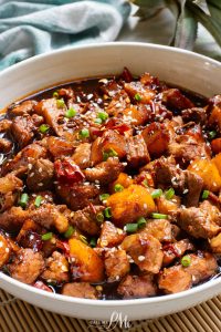 A white bowl filled with Stovetop Pineapple Pork Tenderloin.