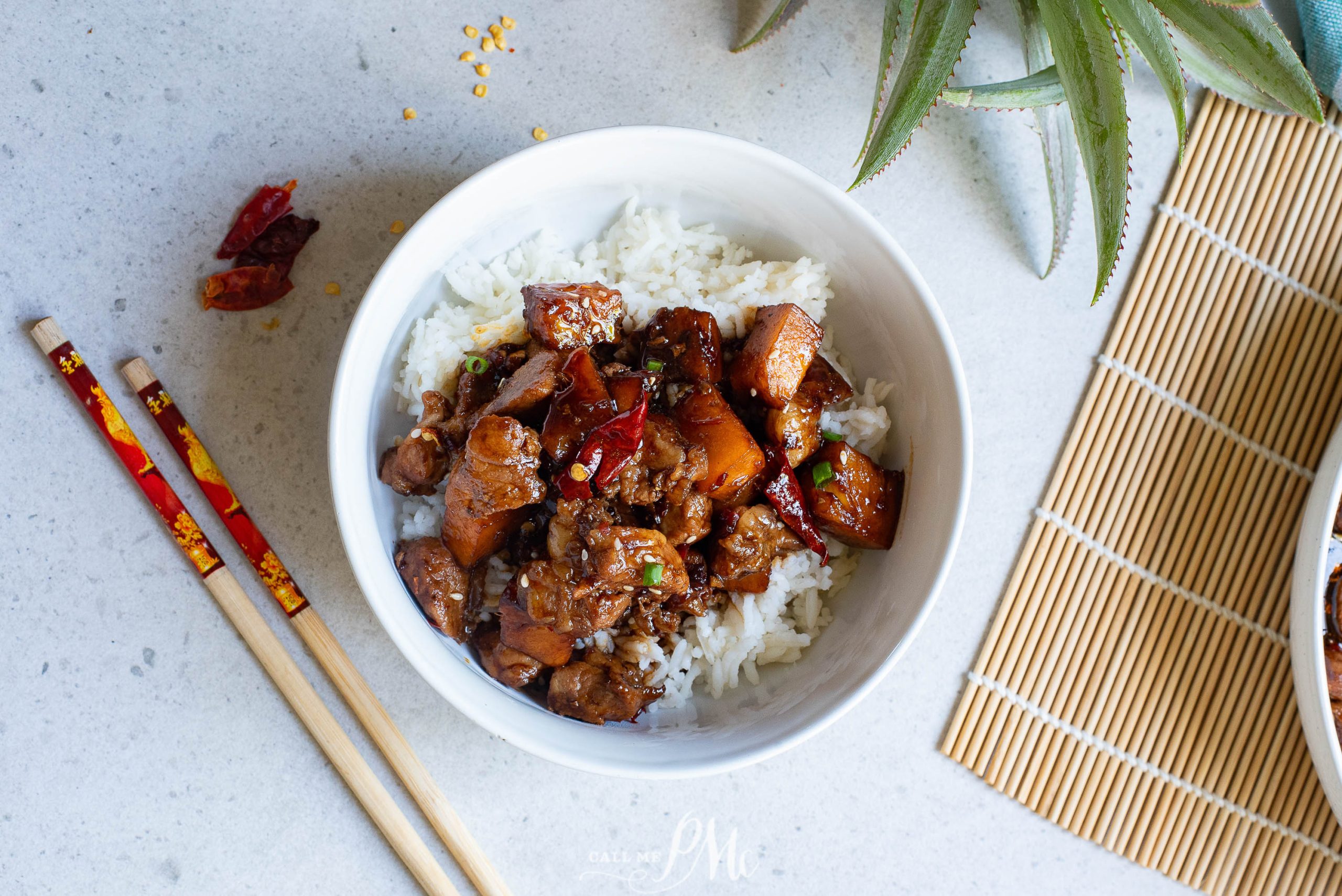 Chinese chicken stir fry with rice and chopsticks.