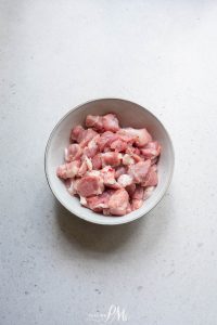 A bowl of raw meat in a white bowl.