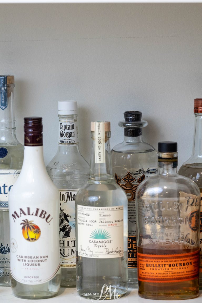 A row of liquor bottles on a shelf.