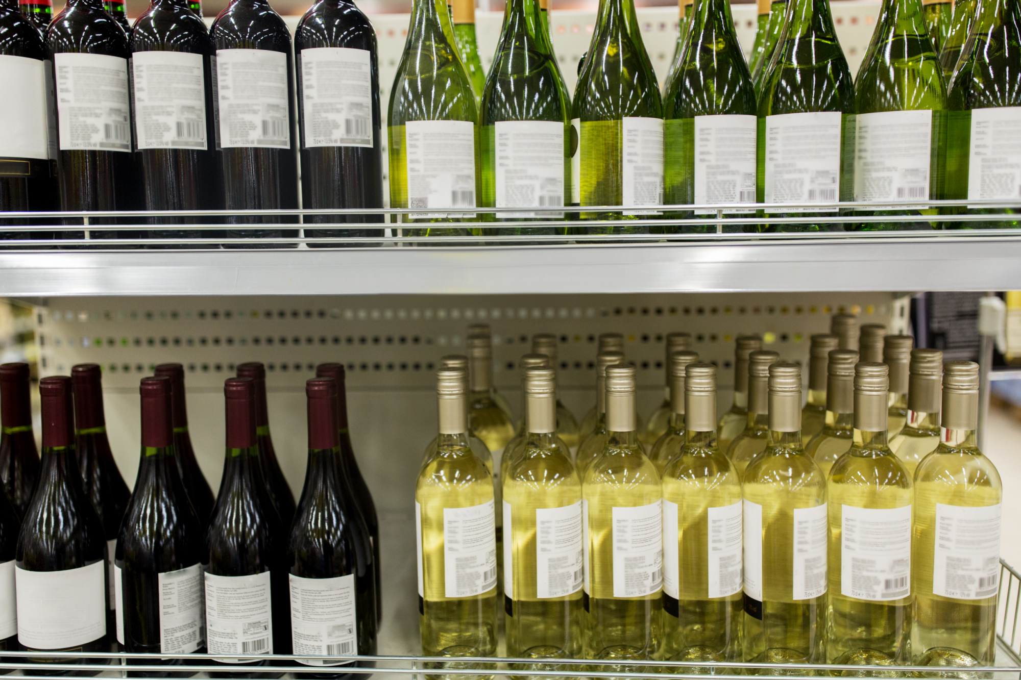 Bottles of wine on a shelf in a store. Does alcohol expire?