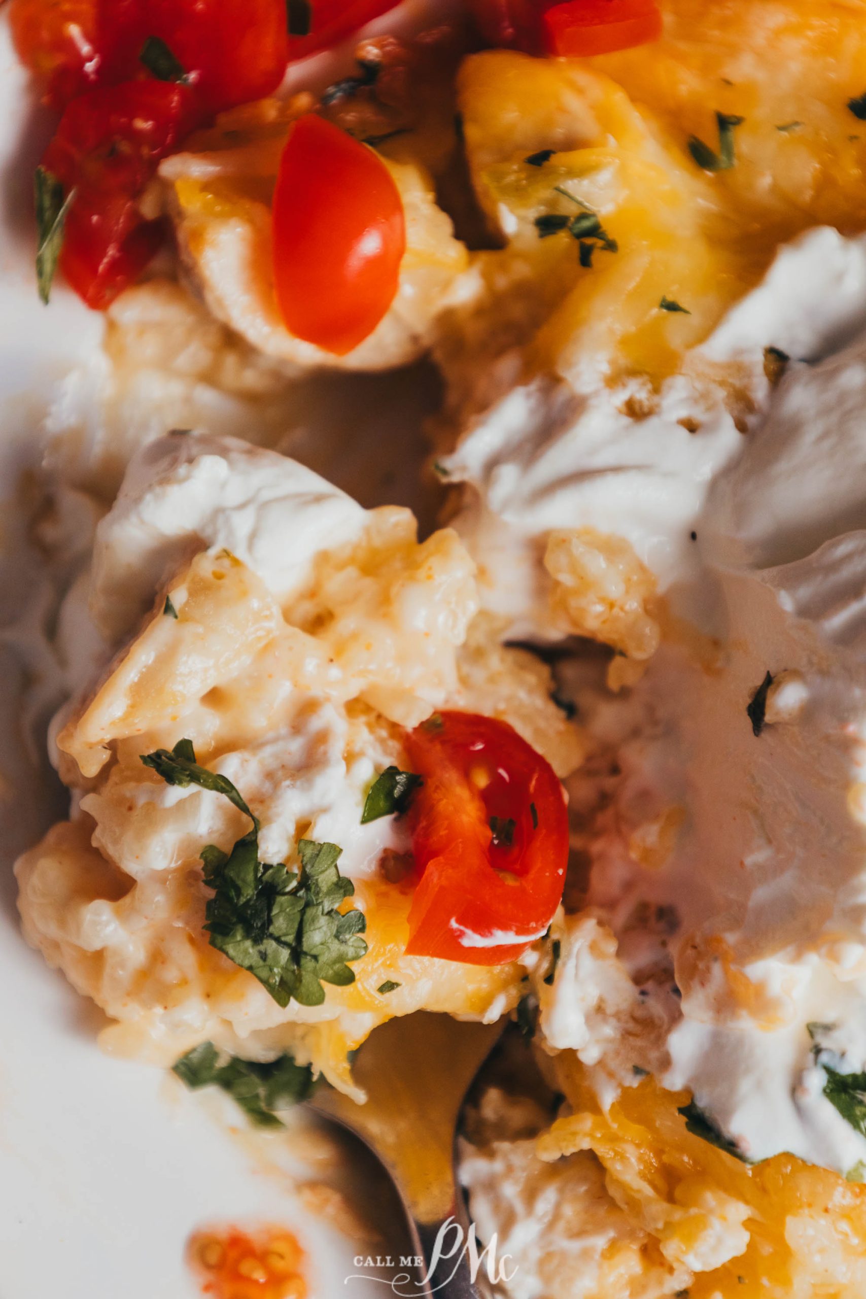 A plate of 30-minute Mexican Chicken Casserole with tomatoes and sour cream.