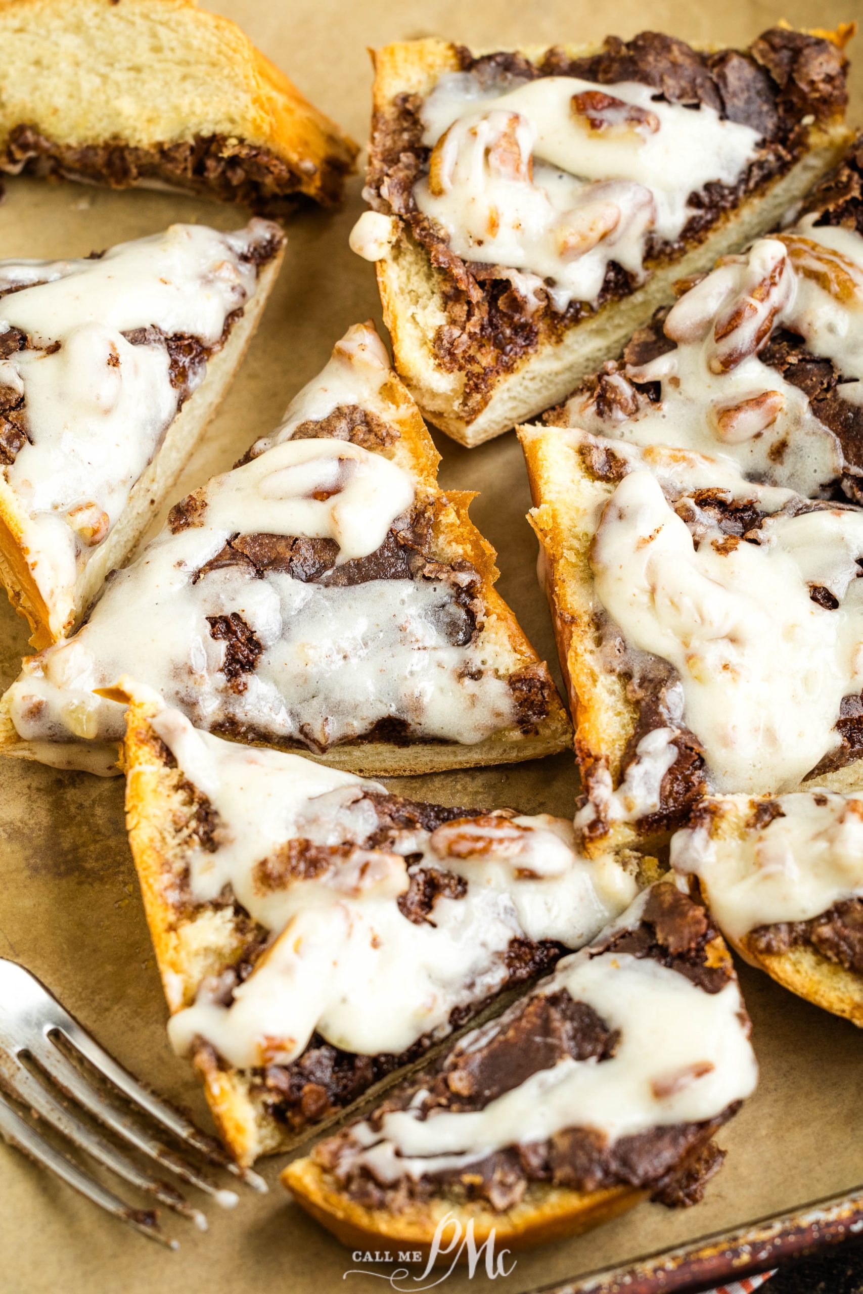 Chocolate pecan pizza slices on a tray with a fork.