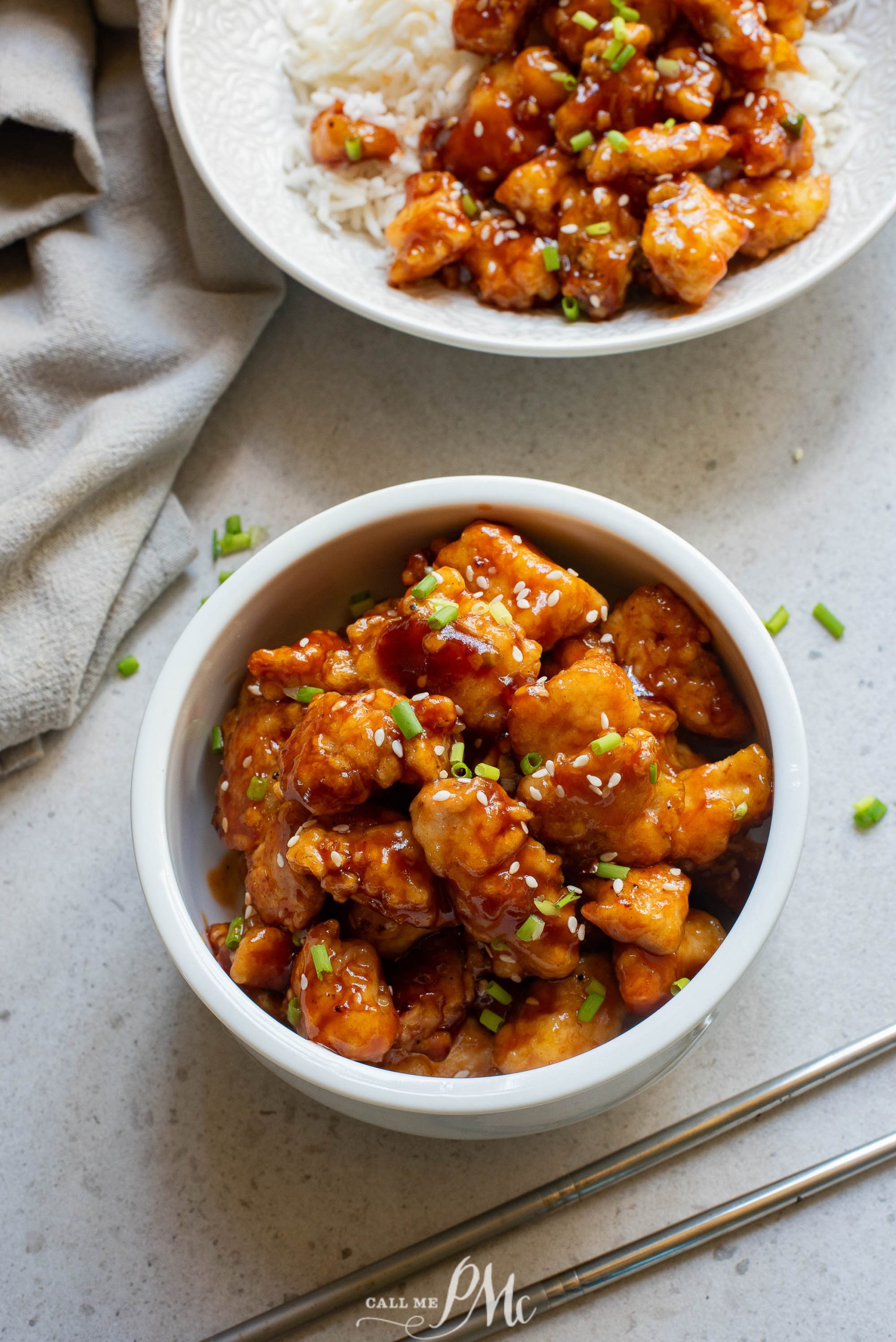 A bowl of Sticky Garlic Chicken Nuggetswith a fork.