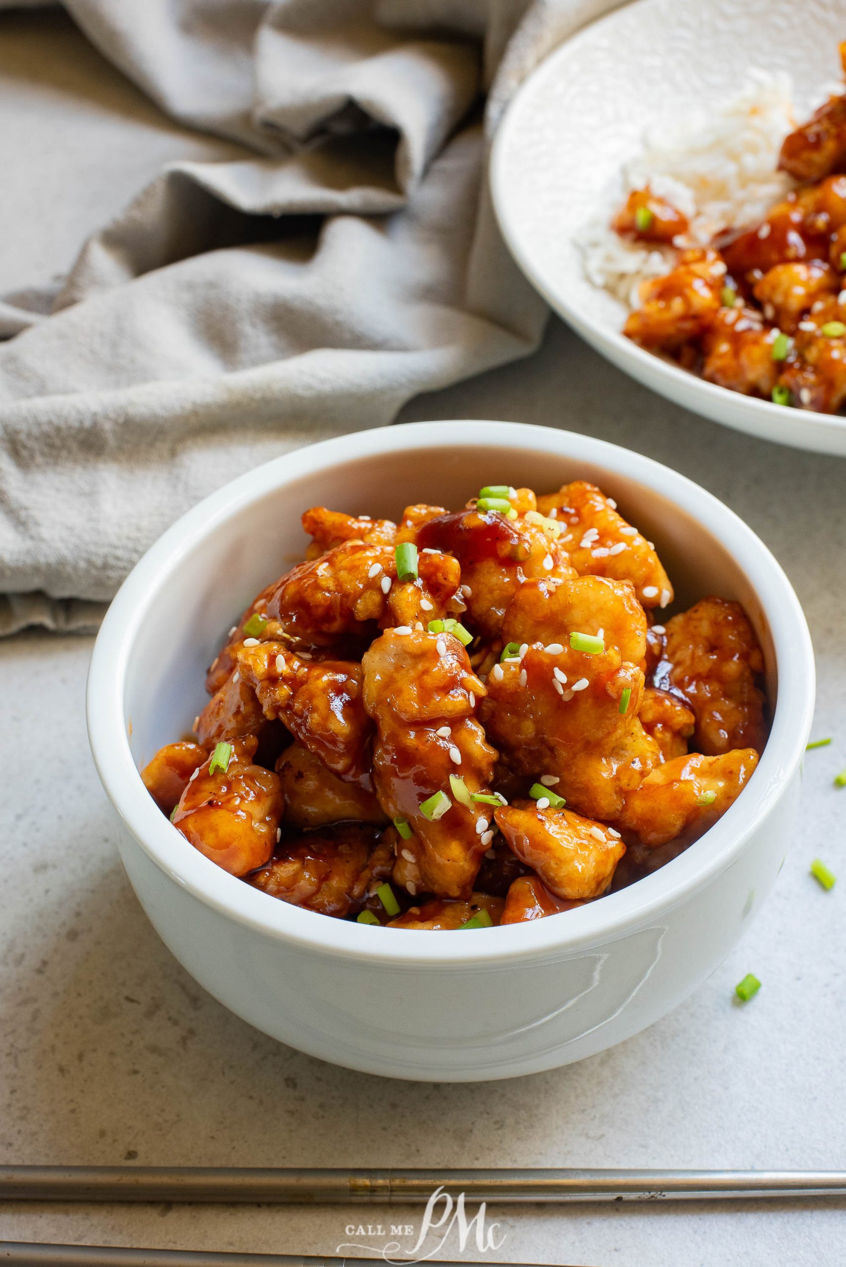 A bowl of food with Sticky Garlic Chicken Nuggets.