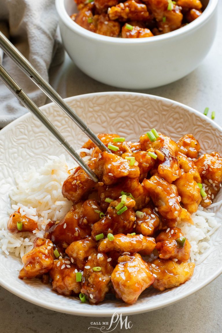 A bowl of food with chopsticks.