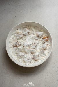 A white plate with powdered sugar on it.