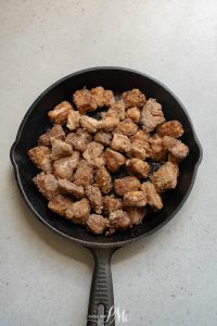 Fried chicken in a skillet on a table.