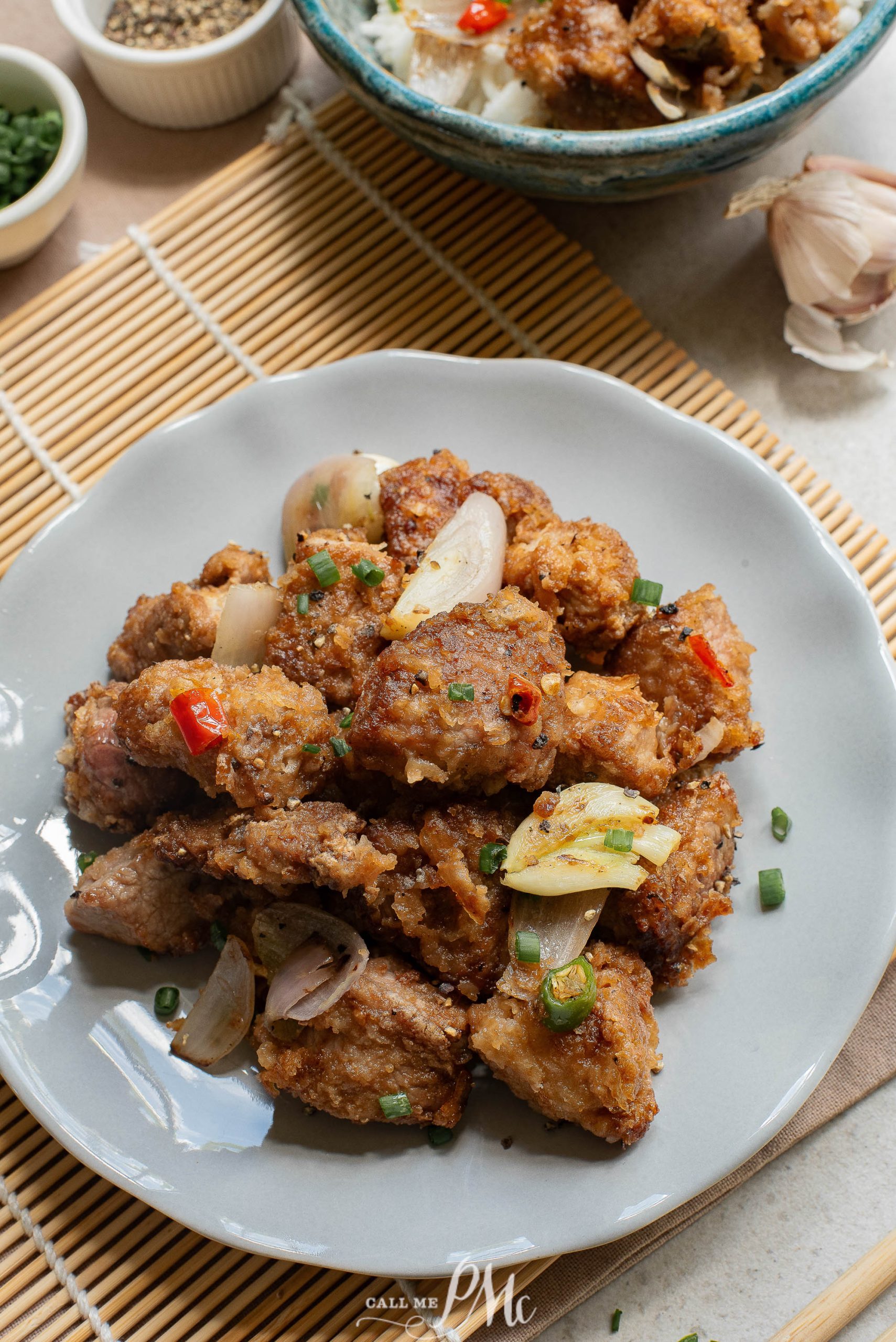 A plate with pork and rice on it.