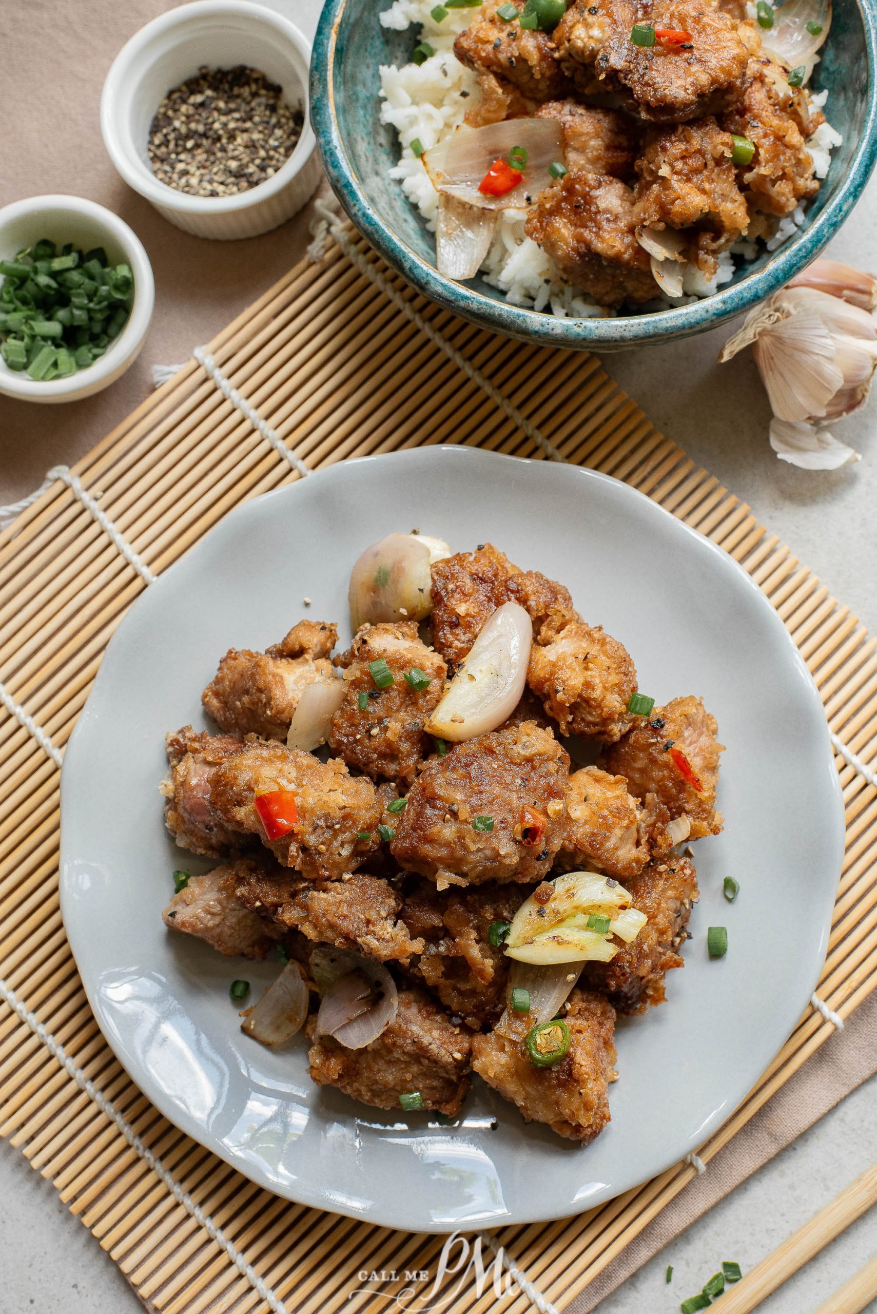 A plate with pork and rice on it.