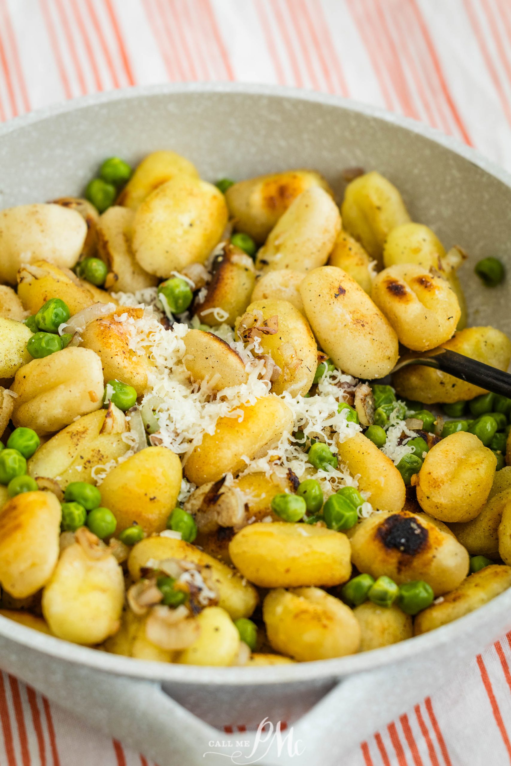 Roasted Garlic Herb Butter Gnocchi and peas in a skillet.
