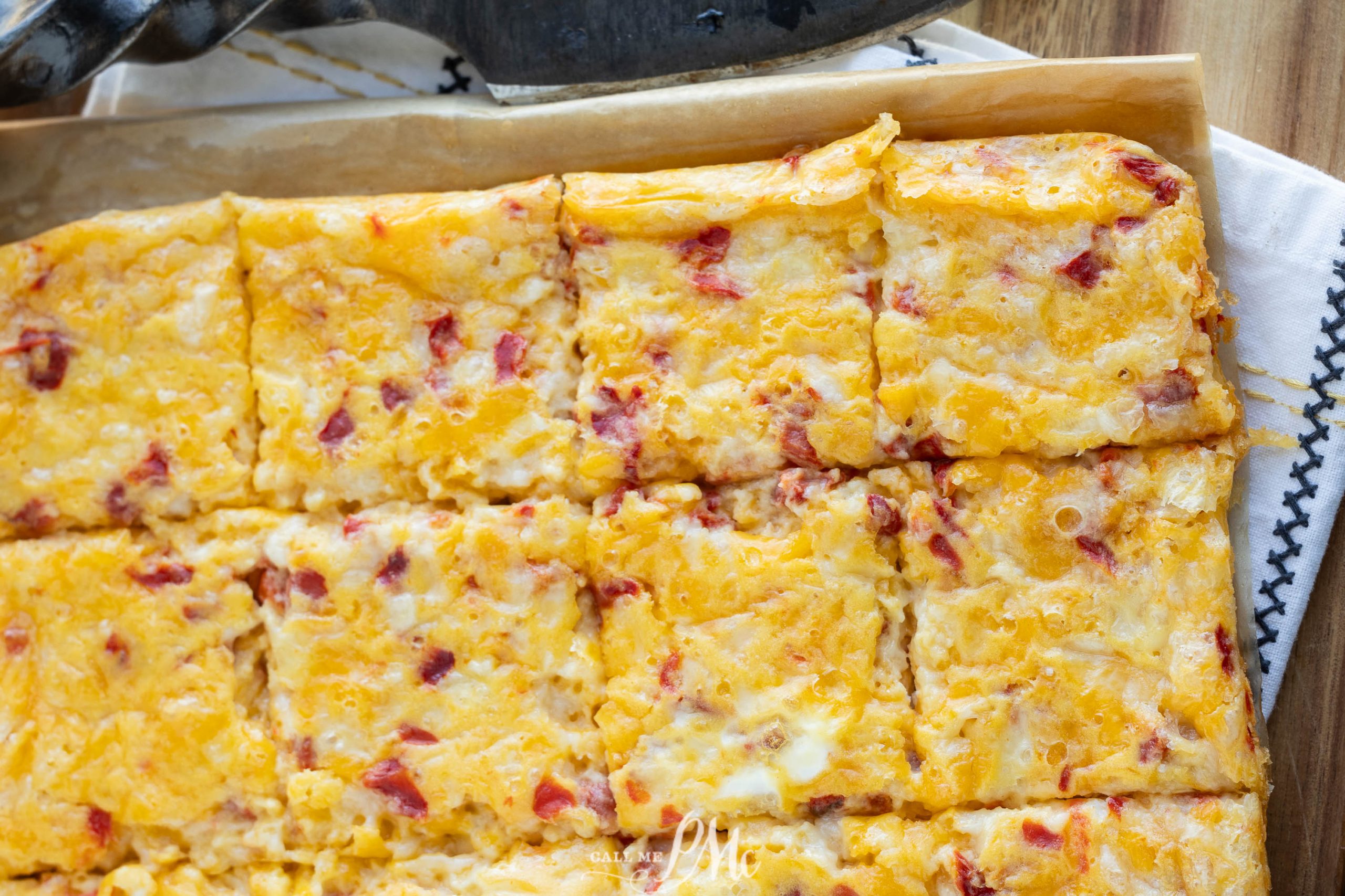 A square of cheese and bacon in a baking pan.