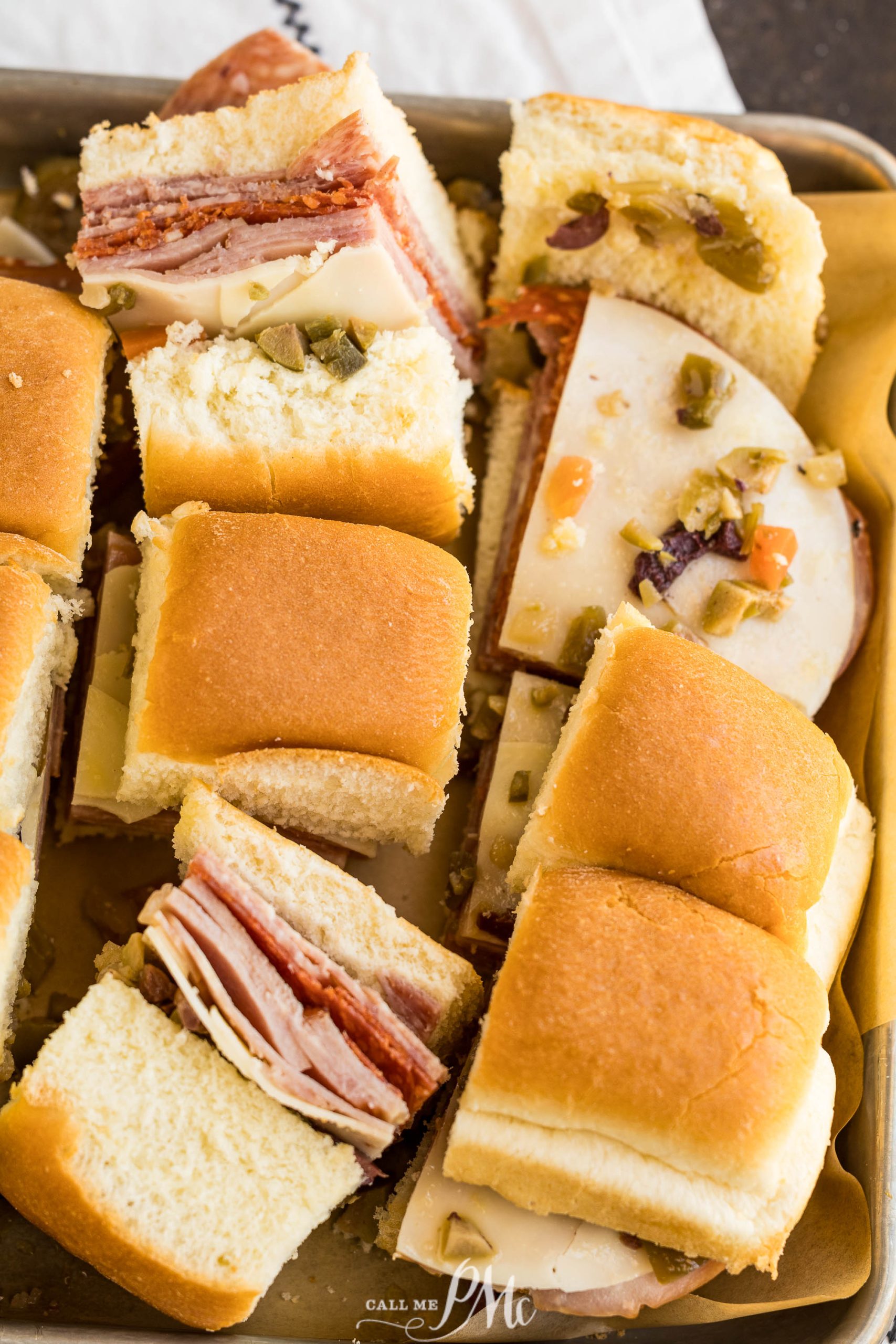 Baked Muffuletta Sliders on a tray.