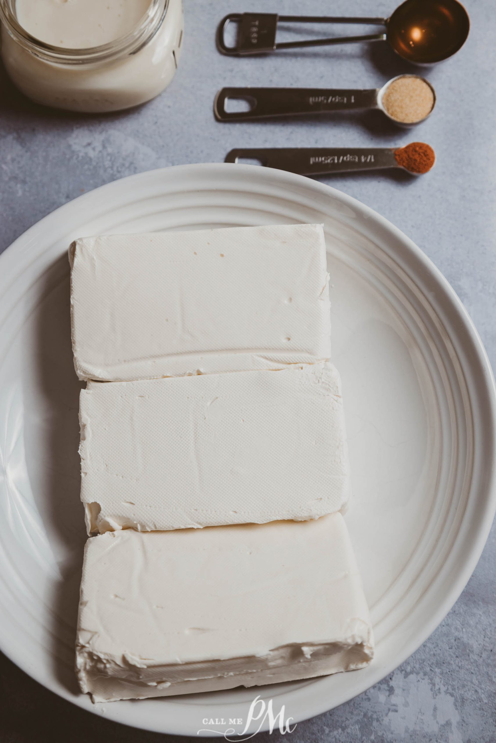 Store Cream Cheese, a white plate with three pieces of creram cheese on it.