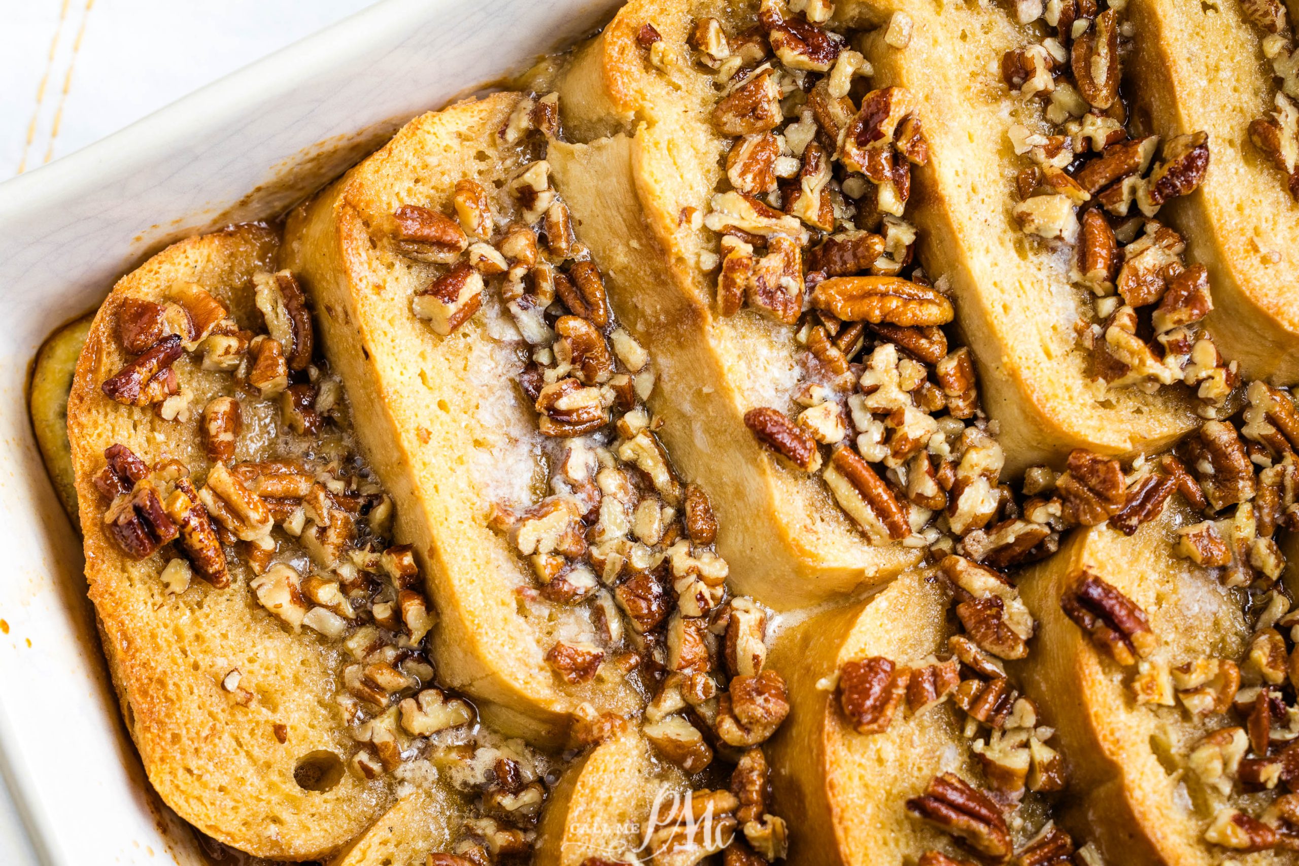 French toast casserole with pecans in a baking dish.