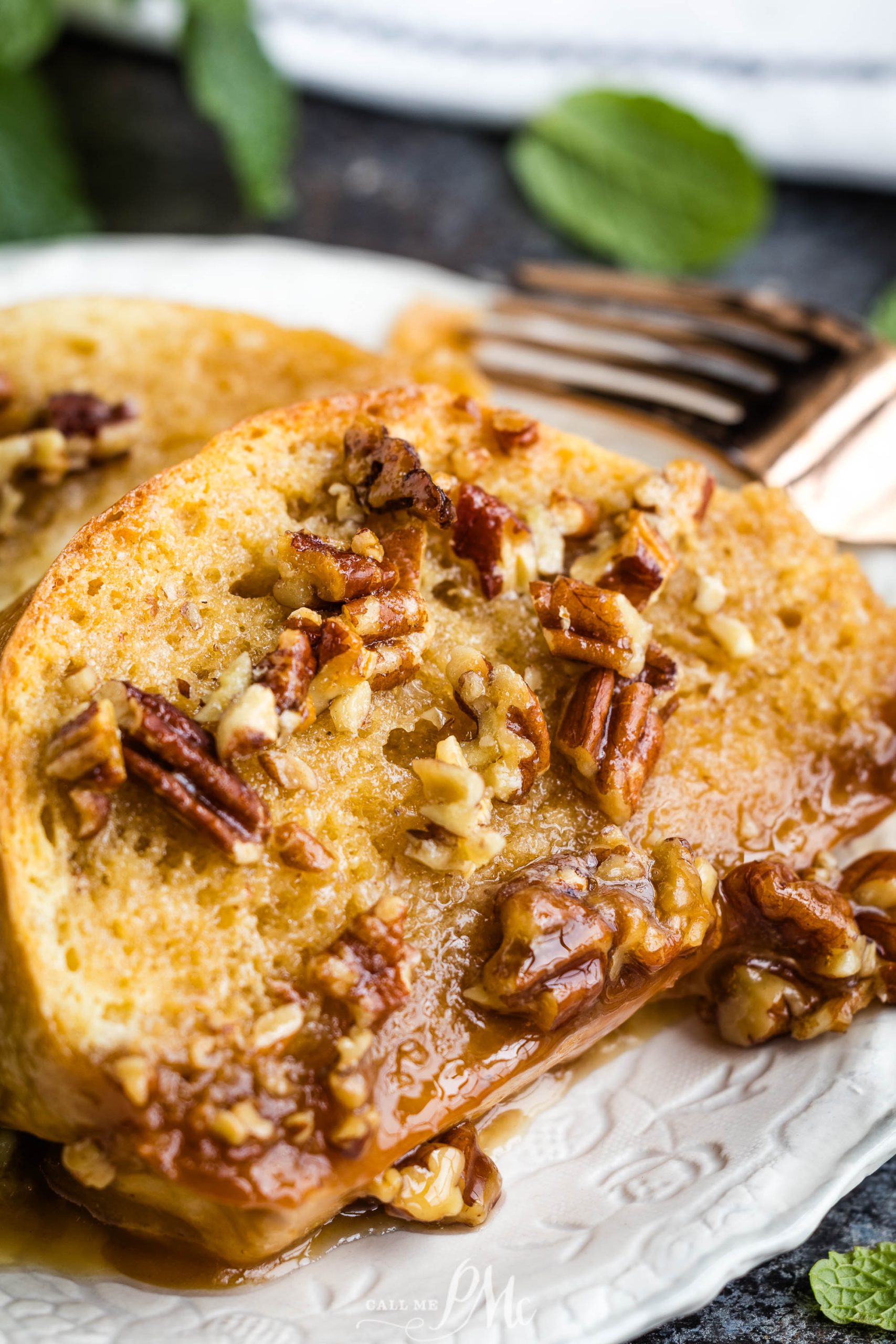 French toast with pecans and maple syrup on a plate.