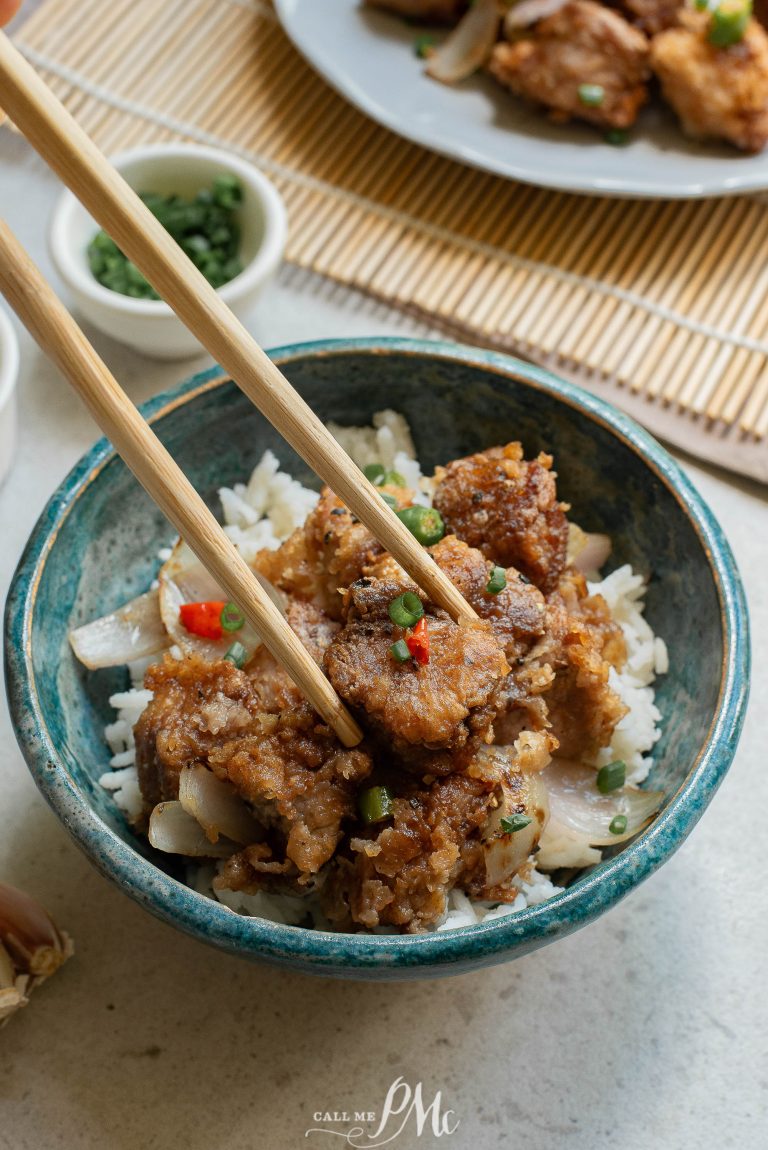 A bowl of food with chopsticks.