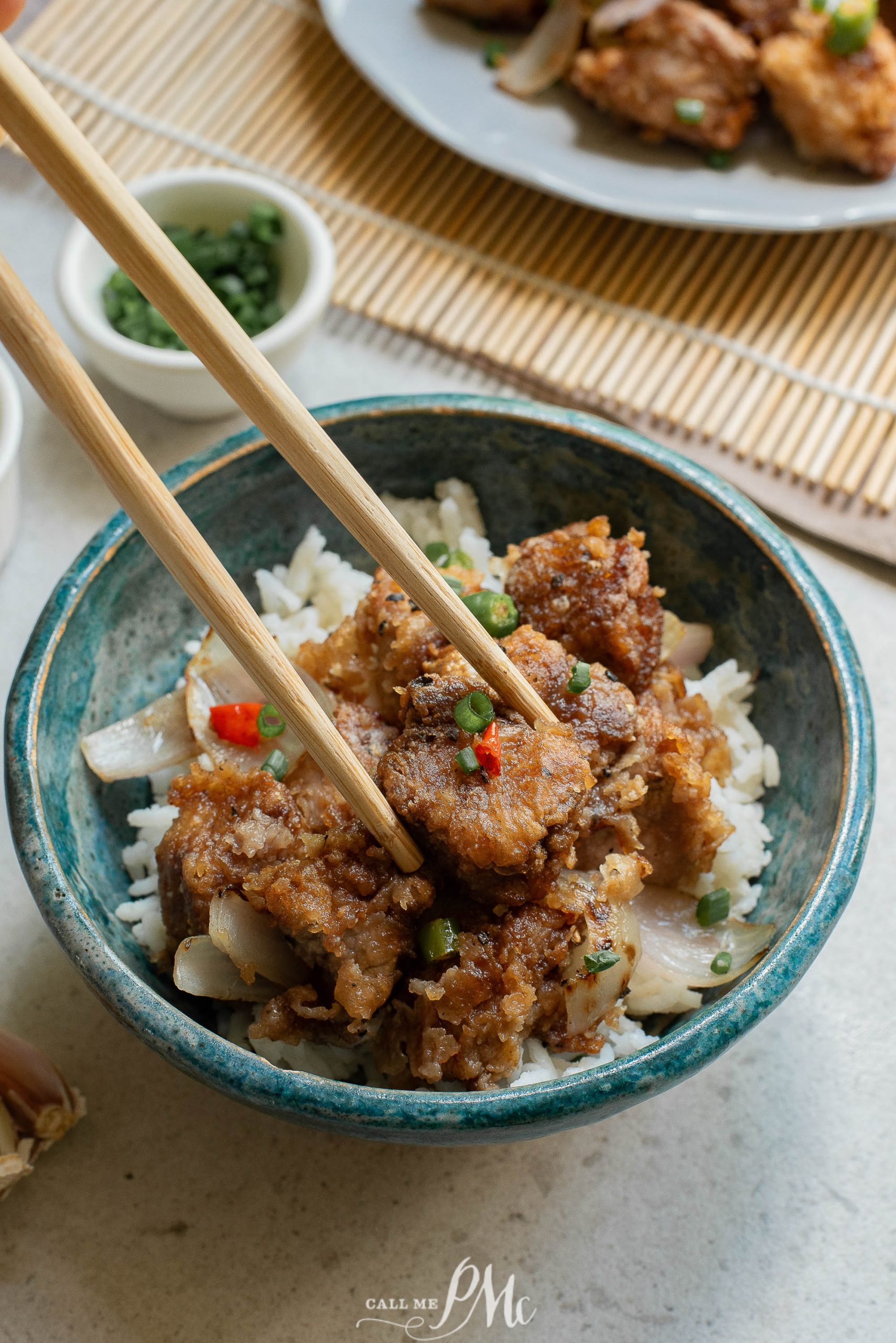 A bowl of fPanko Parmesan Pork Nuggets with chopsticks.