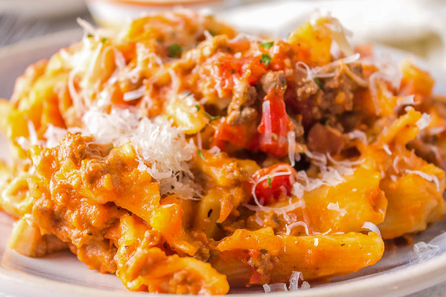 Slow Cooker Cheesy Penne with meat sauce and parmesan cheese.