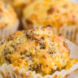 Cheesy sausage muffins on a white plate.