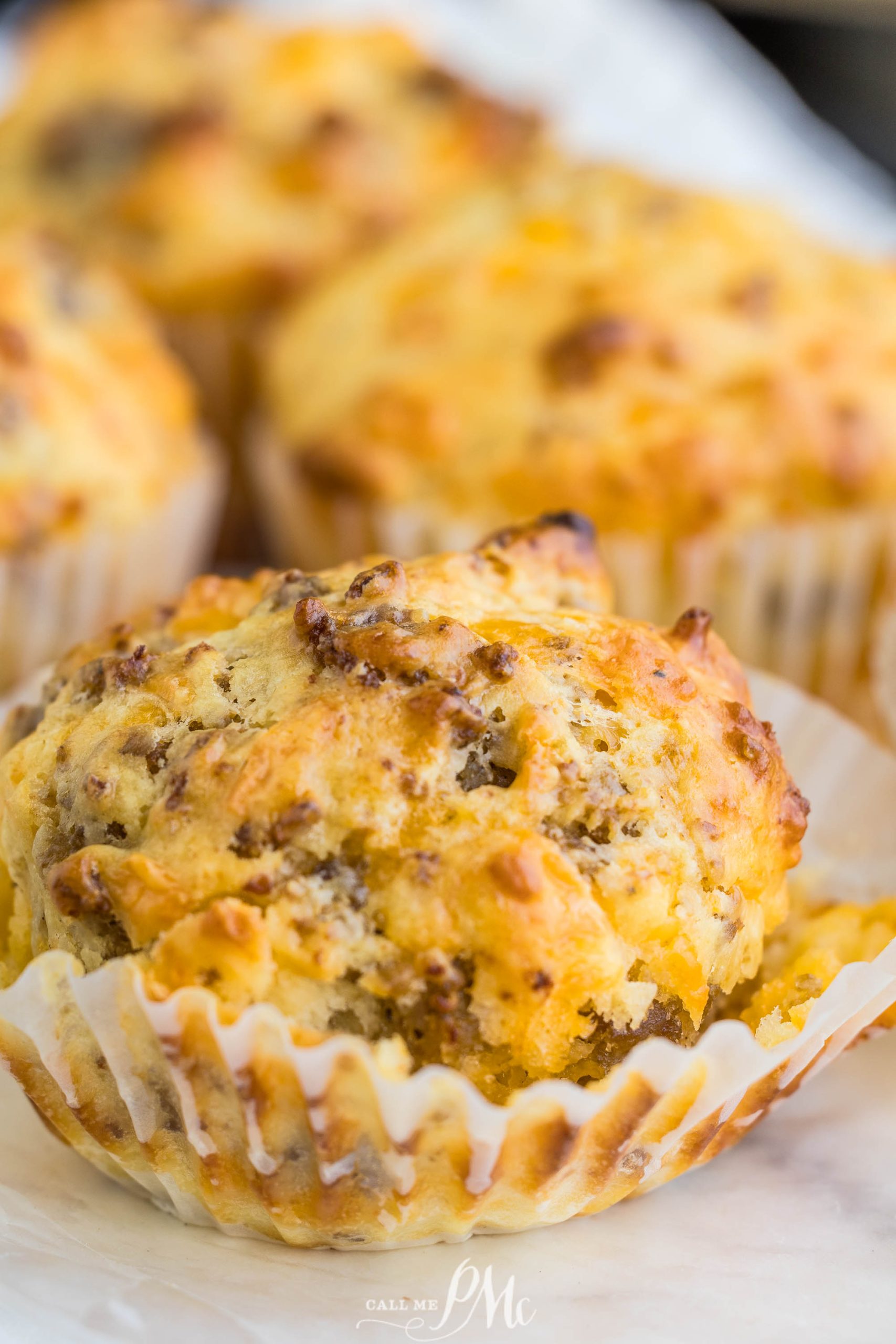 Cheesy sausage muffins on a white plate.