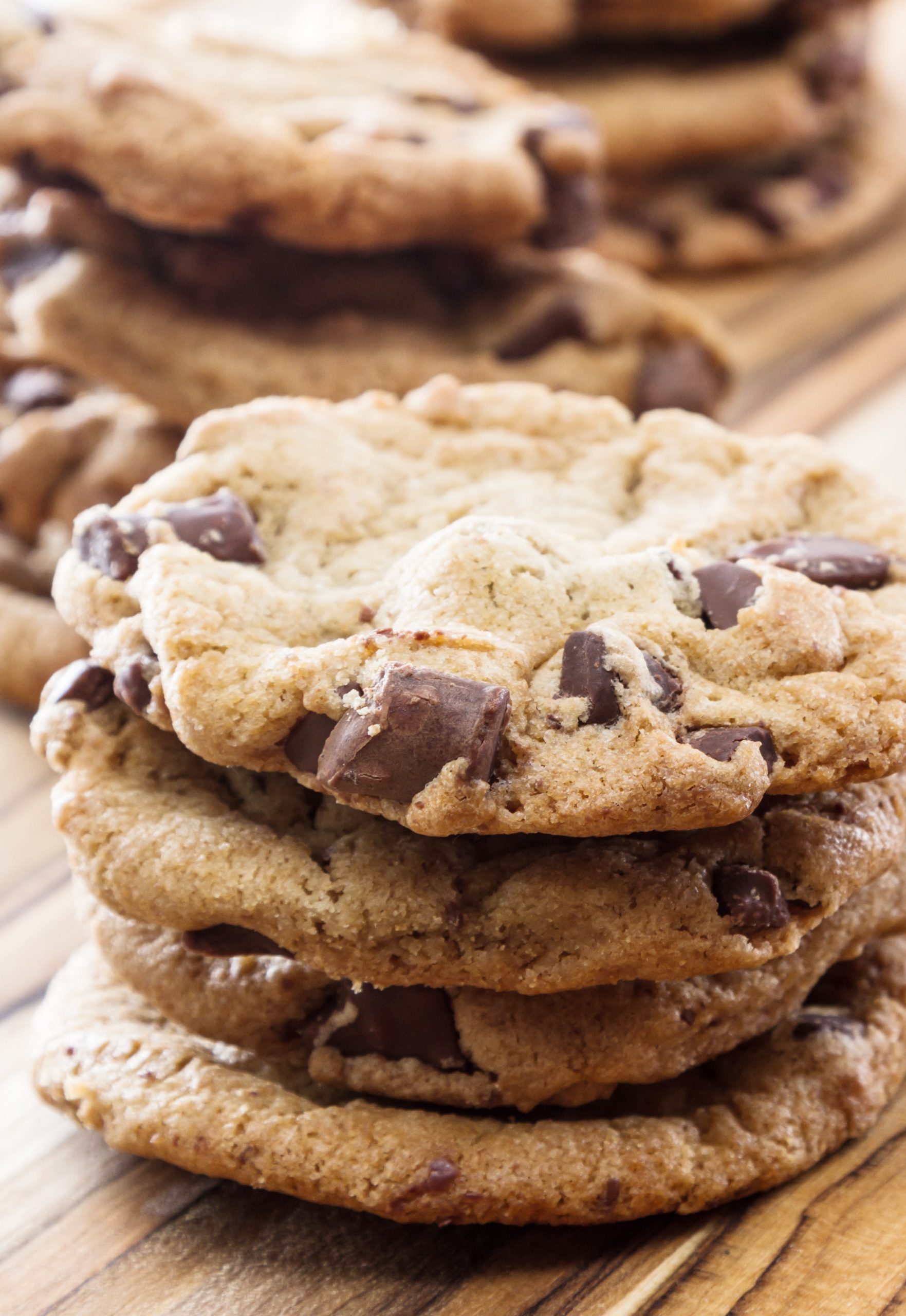 Guiltless chocolate chip cookies arranged on a wooden table.
