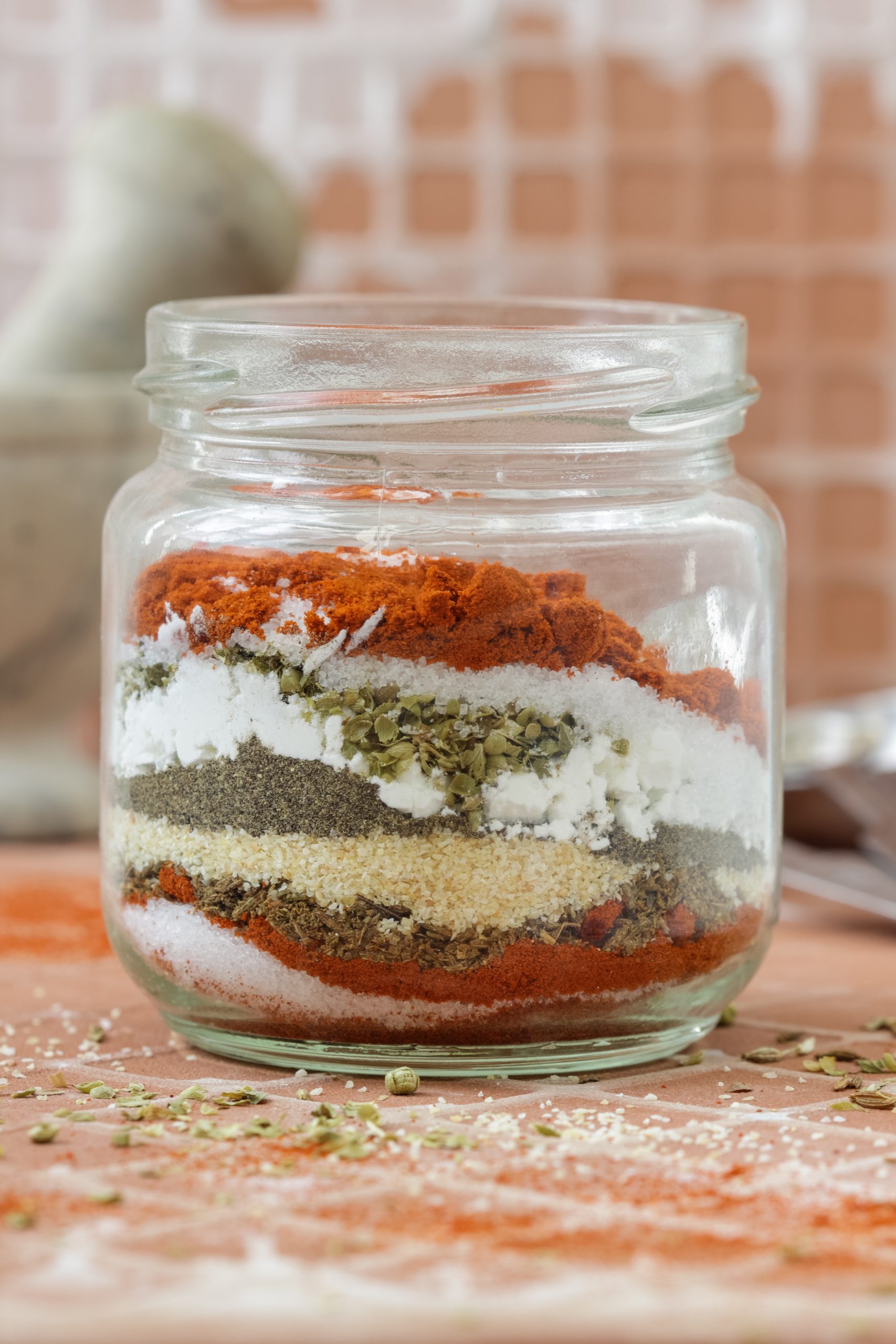 A glass jar with homemade fajita seasoning in it.